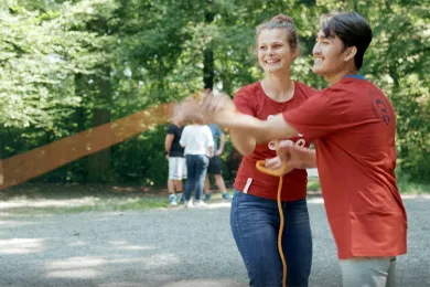 Freiwillige des Jugendrotkreuzes spielen mit Kindern aus dem Asylzentrum im Wald